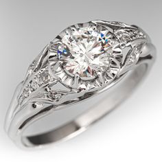 an antique style diamond engagement ring with filigrees