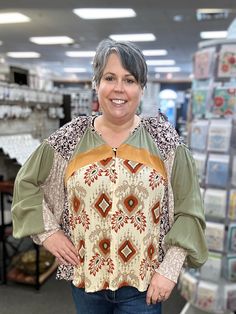 Get ready to make a statement with our Button Front Mixed Print Blouse! This fun top features long sleeves and a v-neckline, perfect for any occasion. With drop shoulders and a playful mixed print design, you'll stand out in all the best ways. (Warning: may cause numerous compliments!) 100% Rayon Jen is wearing her true size XL. Fall Patchwork V-neck Blouse, Fall Tops With Printed Balloon Sleeves, Fall Tops With Balloon Sleeves And Printed Details, Fall Printed Tops With Balloon Sleeves, Patterned Abstract Print V-neck Top, Multicolor Floral Print Top With Balloon Sleeves, Fall Boho Print V-neck Tops, Multicolor Abstract Print V-neck Top, Patterned Patchwork Long Sleeve Tops