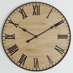 a large wooden clock with roman numerals on it's face and hands