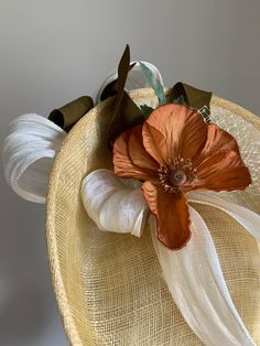 Yellow This smart primrose yellow sinamay disc hat features ivory silk abaca trim and ivory vintage veiling, accented with a copper-coloured vintage poppy flower and vintage olive-coloured ribbon. The hat is fitted with a headband, and is light and easy to wear. This piece is suited to a number of occasions, particularly weddings, Royal Ascot and other race events, and garden parties. The brim is wide enough to give a little bit of drama, but not so wide that you'll feel conspicuous. This shape Fascinator Hats Wedding, Primrose Yellow, Mini Hats, Hat Wedding, Wedding Fascinators, Fascinator Hat, Ivory Silk, Royal Ascot, Garden Parties