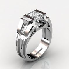 a white gold engagement ring with a princess cut diamond in the center and two baguetts on each side