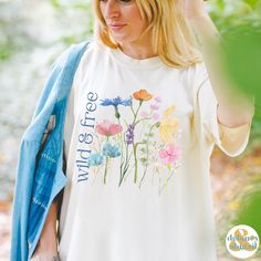 Get ready to be OBSESSED with your new Wildflowers shirt. It's the cutest and most trendy way to emit all those important free spirit vibes! This is the perfect wild & free tshirt! Great gift for the free spirit in your life! Comfort Colors introduces the soft-washed, 100% ring-spun cotton, garment-dyed fabric that brings extra coziness to your wardrobe while the relaxed fit makes it an excellent daily choice. The double-needle stitching throughout the tee makes it highly durable while the lack of side-seams helps the shirt retain its tubular shape.  ❤ The Comfort Colors 1717 tee is made with medium fabric (6.1 oz/yd² (206.8 g/m      consisting of high quality, 100% ring-spun US cotton for long-lasting comfort. ❤ The relaxed fit keeps the wearer comfy in both casual and semi-formal setting Cute Multicolor T-shirt For Spring, Spring Relaxed Fit T-shirt With Watercolor Print, Relaxed Fit T-shirt With Watercolor Print For Spring, Botanical Screen Print Tops For Spring, White Watercolor Print T-shirt For Spring, Botanical Style Screen Print Tops For Spring, Spring Multicolor Screen Print Shirt, Multicolor Watercolor Print T-shirt For Spring, Multicolor Screen Print Shirt For Spring