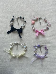 four bracelets with bows and pearls on them