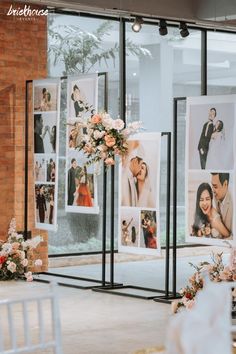 an indoor wedding ceremony with pictures on the wall and flowers in vases next to them