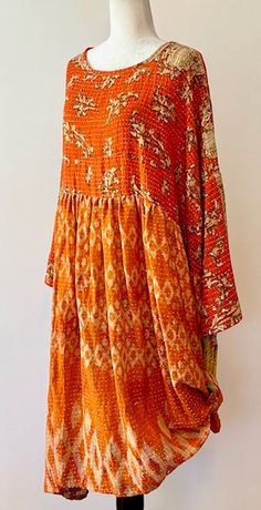 The Daydreamer midi dress is crafted from vintage cotton Kantha embroidered sari. This babydoll inspired silhouhette is both effortless and flattering. It features 3/4 sleeves that are split so you can roll or tie them up, a midi length kantha skirt, a babydoll fit, and POCKETS, of course. Deep pockets to hold all your essentials. We love this style tucked into shorts, worn over wide leg jeans, or styled as a dress on its own. A true boho prairie feel. (Psst...Many customers are removing the bra Bohemian Festive Maxi Dress With Chikankari Embroidery, Festive Bohemian Maxi Dress With Chikankari Embroidery, Bohemian Dresses With Chikankari Embroidery For Navratri, Bohemian Straight Kurta Dress For Festivals, Festive Bohemian Kurta With 3/4 Sleeves, Bohemian Block Print Tunic For Festive Occasions, Traditional Flowy Boho Dress With Boho Print, Festive Bohemian Maxi Dress, Orange Bohemian Cotton Kurta