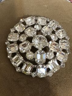 Vintage Signed Weiss Silver-tone Emerald Cut & Round Clear cut Rhinestone Layered Dome Circle Brooch Pin. Measures 2 1/4". Crystal Rhinestone Brooches For Costume Jewelry, Crystal Rhinestone Brooches Costume Jewelry, Crystal Brooches With Rhinestones For Anniversary, Formal Crystal Brooches With Rhinestones, Formal Crystal Rhinestone Brooches, Round Rhinestone Brooches For Formal Occasions, Round Formal Brooches With Rhinestones, Formal Round Brooches With Rhinestones, Formal Round Rhinestone Brooches