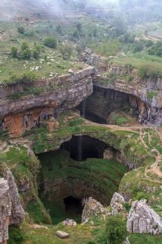 a large cave with a waterfall in the middle