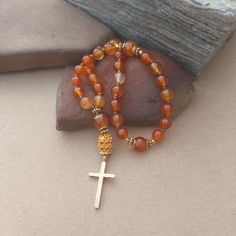 These Anglican Prayer Beads are made with natural Carnelian stone beads. The 10mm Cruciform Beads are framed with gold daisy and spacer beads. The cross is a hammered gold Spiritual Carnelian 8mm Bead Jewelry, Spiritual Carnelian Beads Jewelry 8mm, Carnelian Beaded Bracelets With Natural Stones For Meditation, Carnelian Gemstone Beads Bracelet For Meditation, Spiritual Carnelian 8mm Beaded Jewelry, Amber Agate Beaded Bracelets Spiritual Style, Spiritual Carnelian Jewelry With 8mm Beads, Amber Agate Beaded Spiritual Bracelets, Spiritual Amber Agate Beaded Bracelets