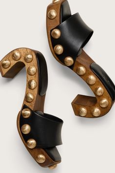 A sculptural mule designed with a curved wood frame, smooth leather straps and textured brushed brass studs. - Smooth nappa leather straps and sole - Moire textured brushed brass studs Luna Sandals, Unique Heels, Clear Shoes, Embroidered Flats, Luxury Designer Shoes, Curved Wood, Cult Gaia, Unique Shoes, Brushed Brass