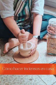 a person is making something in a blender on the floor next to some spices