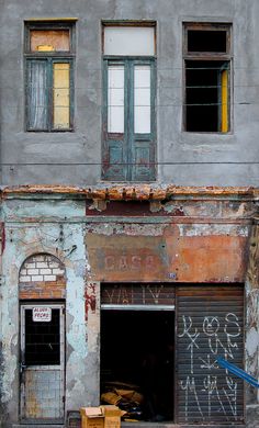 an old run down building with graffiti on it