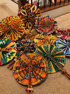 Ankara Print Hand fan, made in Ghana. Fans are randomly selected unless otherwise specified. All fabrics are colorful Africa fabrics handmade into hand fan or Africa fan. Hand  fan fold with real leather handles wrapped around bamboo. Handmade fan that is foldable and fits inside your purse. This can also be used as an African inspired wall hanging decor. Foldable dimensions: about 12" x 2.7" Open dimensions: about 12"  x 15" Can be used as a practical statement piece fan on special occasions su Africa Theme Party, Hand Fans Diy, Diy Dollar Tree Centerpieces, Dollar Tree Centerpieces, Fan Hand, African Theme, African Accessories, Gold Party Decorations, Ankara Print