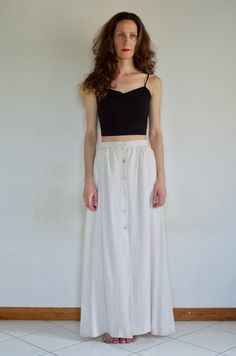 Gorgeous and elegant White silk maxi skirt from the always classic Valentino boutique. Minimalist cool style will make you look chic for any occasion. Infinitely wearable and modern. Silk is an off white. Skirt is slim and sleek - Slight gathers at waist, five big mother of pearl buttons up the front, open at the knee to show some leg. At waist there is a snap and a hook. Fully lined. Side pockets!!Label Valentino Boutique Roma Made in Italy, 100% pure silk, dry clean only, size 10. Very good vi Elegant Maxi Skirt, Off White Skirt, Silk Maxi Skirt, Silk Maxi, The White Company, Style Minimaliste, White Skirt, White Silk, Pearl Buttons