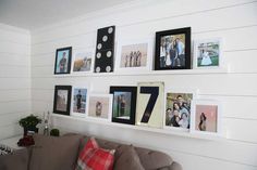 a living room filled with furniture and pictures on the wall above it's couch