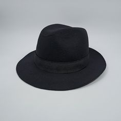 Only size:60cm. Note: Glue marks are visible on the material. The seams show irregularities in different areas. Air bubbles are visible in the hat. The hat has an additional rubber banding. The overall appearance is shown on the supplied images. Cosy and breathable fedora made of black woolen material, the cap has a lining and is undoubtedly not a felt hat, but rather carefully sewn. The discrepancies between the felt and sewn caps are noticeable. While felt hats are often seen as more polished, Classic Black Fedora Panama Hat, Fitted Black Classic Panama Hat, Black Fitted Classic Panama Hat, Classic Black Fitted Panama Hat, Adjustable Black Felt Bucket Hat, Black Panama Hat With Short Brim For Formal Occasions, Black Brimmed Panama Hat For Formal Occasions, Black Formal Panama Hat With Wide Brim, Black Wide Brim Panama Hat For Formal Occasions