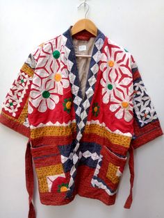 Traditional Outerwear With Patchwork And Kimono Sleeves, Embroidered Cotton Outerwear With Kimono Sleeves, Bohemian Outerwear With Multicolor Embroidery And Pockets, Embroidered Cotton Kimono For Fall, Fall Embroidered Cotton Kimono, Embroidered Multicolor Kimono For Winter, Embroidered Winter Outerwear With Kimono Sleeves, Red Folk Cotton Outerwear, Embroidered Multicolor Winter Kimono