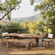 a wooden table and two chairs on a deck