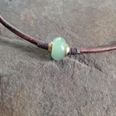 This may be the gift you are searching for.  Minimalist and earthy men's, women's or unisex semiprecious gemstone on leather choker necklace. I placed a nice large Green Aventurine gemstone rondelle bead on substantial 3mm brown leather cord and enclosed it on both sides with brass spacer beads.  These beads are all secured in place with waxed cord wrapped in a complimentary fashion, adding to the earthy natural style of this piece.   This necklace is casual and natural and easy to wear.  It has Cheap Adjustable Cord Choker, Everyday Necklaces With Sliding Knot And Waxed Cord, Everyday Waxed Cord Jewelry With Sliding Knot, Everyday Jewelry With Sliding Knot In Waxed Cord, Casual Aventurine Jewelry For Gifts, Brown Waxed Cord Jewelry For Healing, Leather Necklace Diy, Boho Surfer Style, Leather Cord Jewelry