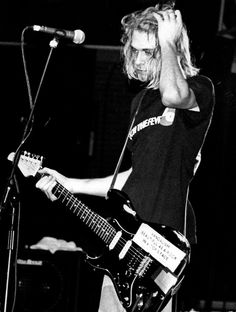 black and white photograph of a man playing an electric guitar