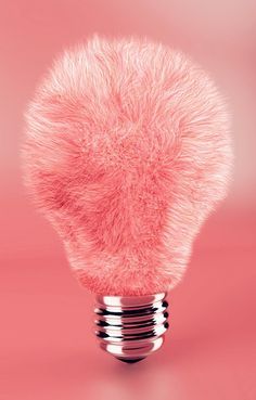 a pink light bulb that is shaped like a furry ball on top of it's head