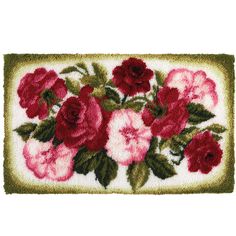 a red and pink flowered rug with green leaves on the bottom, white background