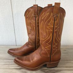 Vintage Rodeo Boot Co Mens Hazelnut Brown Cowboy  Western Boots 7 D M29 USA Size US 7 D Made in USA Vintage Bootmaker Rodeo Model M29 Style Western MSRP $239 Top Grain Medium Luster Brown Leather Vamp & Counter Top Grain Medium Luster Brown Leather Shaft Gold Western Stitched Shaft Single Stitch Welt Leather Lining Half Inch Platform Leather Soles Leather Insoles J Toe 2.25" Shaft Dip 12.00" Shaft 2.00" Heel 13.75" Floor to Shaft Top 14.00" Calf Circumference Features: * Western Size: Mens 7 Condition: Pre-Owned Good Please review all photos. Vintage. Light wear. Very good /excellent condition.  Fast shipping in the USA Rodeo Boots, Mens Cowboy, Photos Vintage, Cowboy Western, Mens Shoes Boots, Western Cowboy Boots, Counter Top, Vintage Shoes, Western Boots