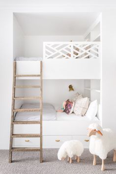 a white bunk bed sitting next to a wooden ladder in a child's room