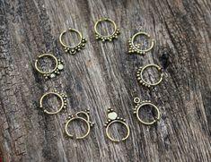 "Sellers tip : Buy more than 1 item from our shop to save shipping cost. Brass septum Ring, 9 Designs are suitable for other piercings as Helix, Tragos and more. These Fake Septum Rings not require a hole and comfortable for wearing. In above pictures you can see the number of each design, please select the desired design. Note:- These are not stock photos - these are actual photos taken of the item listed. However, since screen resolutions vary, the colors \"in-person\" may be slightly differen Handmade Bohemian Round Nose Rings, Handmade Bohemian Round Septum Ring, Bohemian Handmade Round Septum Ring, Bohemian Adjustable Septum Ring As Gift, Bohemian Adjustable Septum Ring Gift, Adjustable Round Bohemian Nose Rings, Nickel Free Metal Septum Ring As Gift, Nickel-free Metal Septum Ring As Gift, Adjustable Metal Septum Ring For Gift