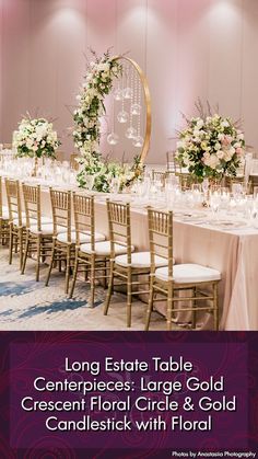 the long table is set up with white flowers and greenery in front of it