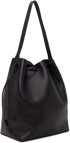 Polished saddle calfskin tote in black. · Fixed shoulder strap · Gold-tone logo stamp at side · Drawstring closure · Zip and patch pocket at interior · H14.5 x W12 x D7 Supplier color: Black Elegant Black Bucket Bag With Smooth Grain, Classic Black Bucket Bag For Business, Classic Black Business Bucket Bag, Classic Leather-lined Bucket Bag For Work, Black Smooth Grain Shoulder Bag For Work, Black Calf Leather Bucket Tote Bag, Classic Calf Leather Bucket Bag For Business, Business Black Leather Lined Bucket Bag, Black Smooth Grain Bucket Bag