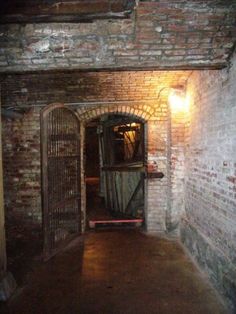 an old brick building with a door open