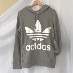 Grey Adidas Logo Hoodie White Adidas Sweatshirt With Letter Print, Adidas White Sweatshirt With Letter Print, Adidas White Sweatshirt With Graphic Print, Adidas Casual Sweatshirt For Fall, Casual Adidas Hoodie For Winter, Fall Adidas Tops, White Long Sleeve Adidas Sweatshirt, Adidas Logo Hoodie For Fall, White Adidas Logo Cotton Sweatshirt