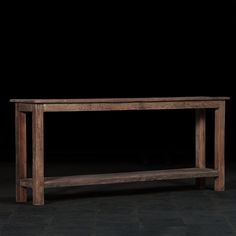 a wooden bench sitting on top of a black floor