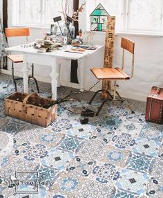 a room with a table, chair and ruler on the floor in front of it