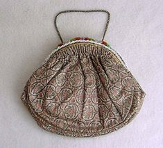 "A Truly Elegant 1900's Antique French Gold Silk Brocade Opera Purse In Superb Vintage Condition. The dance purse is 6\" tall and 7\" wide. The evening bag features a fabulous gold brocade cloth with stylized floral designs topped with a multicolored floral beaded frame and clasp highlighted with intertwined white rope glass beads. The intricate bead work runs that entire length of the long arched frame on both sides. The opera purse measures 9\" in length and 1\" wide. The beaded clasp pushes u Antique Gold Embroidered Bags, Victorian Style Gold Embroidered Bag, Antique Style Multicolor Evening Bags, Beaded Frame, Silk Purse, Bead Frame, White Rope, Gold Brocade, French Silk