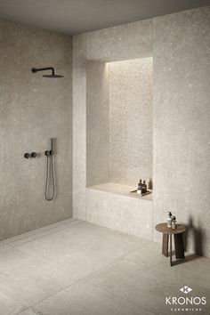 a bathroom with a tub, shower head and two faucets on the wall