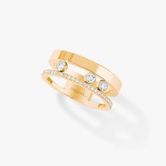 a yellow gold ring with two diamonds on top and an open band in the middle