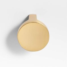 a gold door knob on a white wall