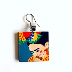 100% Hand Painted Frida Earrings, and made from scratch. Every single element such as metal jump rings, wood and hook earring findings was assembled by hand. Original Artwork. No Prints. This gorgeous hand painted Frida earrings are a beautiful mini masterpiece. Original Artwork. We created them using high quality acrylic paint which had been protected with a special gloss coat to ensure its durability.Very light to wear and one of a kind accessory. It's the perfect gift for that very special pe Quirky Multicolor Dangle Jewelry, Artistic Hand Painted Turquoise Jewelry, Artistic Hand-painted Turquoise Jewelry, Artistic Hand Painted Earrings For Gifts, Artistic Enamel Earrings With Artistic Design, Artistic Design Enamel Earrings, Artistic Blue Earrings As Gift, Blue Quirky Earrings As Gift, Artistic Nickel-free Resin Jewelry