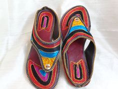 Bohemian shoes, colourful women's sandals from Punjab: Fashion footwear for the contemporary city dweller, from five centuries back. Mumtaz, the lady for whom the Taj Mahal was built probably lived in shoes and sandals much like these. Originally meant for the Maharajahs and the Maharanis [Kings and Queens and such royalty], these handcrafted fashion footwear for men and women mainly come from the villages of Punjab and Rajasthan. This period fashion piece was introduced to India during the Mugh Traditional Sandals With Single Toe Strap For Festive Occasions, Festive Sandals With Gota Work For Diwali, Traditional Festive Sandals With Single Toe Strap, Traditional Closed Toe Toe Ring Sandals For Festivals, Traditional Slip-on Toe Ring Sandals For Beach, Traditional Toe Ring Slip-on Sandals For Beach, Traditional Slip-on Huarache Sandals Fair Trade, Traditional Fair Trade Huarache Sandals, Open Toe, Traditional Fair Trade Sandals With Round Toe