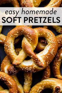 pretzels with sesame seeds and sea salt are arranged on a blue surface, ready to be eaten