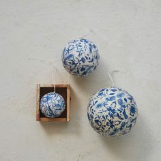 two blue and white vases sitting on top of a wooden box next to each other