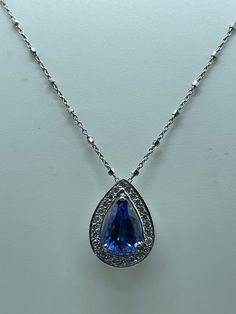 This stunning 14k white gold necklace features a teardrop-shaped AAA+ tanzanite stone which weighs approximately 4.11 carat, surrounded by 67 natural diamonds which weighs approximately 1.22 carat with a total carat weight of 5.33. The deep purplish blue color of the main stone is complemented by the excellent cut grade and prong setting style.  Perfect for Mother's Day, Christmas, Anniversary, Birthday, or Valentine's Day, this necklace has a lobster closure and is 18 inches in length, with an Formal Tanzanite Teardrop Jewelry, White Gold Tanzanite Jewelry In Pear Shape, Tanzanite Necklace, White Gold Necklace, Tanzanite Stone, White Gold Necklaces, Prong Setting, Natural Diamonds, Necklace Etsy