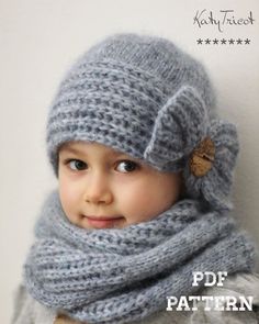 a little boy wearing a knitted hat and scarf with a button on the side