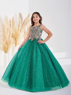 Your sweet girl will love twirling around in this sequin applique long sleeveless dress with A-line shimmer tulle skirt by Tiffany Princess 13690. Scoop neck sleeveless with fully sequined lace applique bodice, shimmer glitter tulle ballgown skirt, and a lace-up back. House of Wu Tiffany Princess Collection Fall 2022 Style Number: 13690 Fabric: Sequin Lace Appliques/Shimmer Tulle Please note: There may be a loss of glitter while wearing this dress due to the nature of the fabric Colors: Emerald Sleeveless Embellished Dress With Glitter Tulle, Embellished Green Ball Gown For Pageant, Embellished Green Ball Gown For Pageants, Sleeveless Sequin Pageant Dress, Sequin Sleeveless Gown For Pageants, Sleeveless Glitter Tulle Dress For Pageant, Green Sequined Dresses For Pageants, Back House, Tulle Ballgown