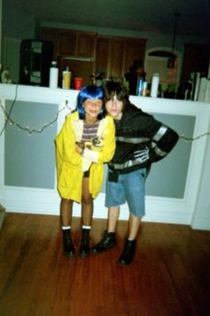 two young people standing next to each other on a hard wood floor