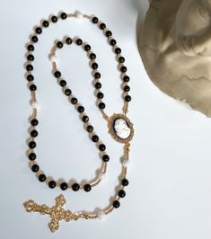 This Luxurious Rosary is uniquely designed and hand-made exclusively at Reminiscent Rosaries & Designs.  Each piece is made with only the highest-quality domestic/imported materials and made to last.  --- Full length of Rosary measures approximately 20.5". --- 8mm Obsidian and Pearl beads --- Anti Tarnish / Tarnish Resistant --- Perfect for any special occasion or Religious event --- Ready to ship in 1-2 business days Your experience matters most to us at Reminiscent Rosaries.  Please reach out if you have any questions or concerns. Follow our journey and get firsthand insight into the latest designs! IG: @reminiscentrosaries Elegant Rosary With Round Beads For Healing, Elegant Healing Rosary With Round Beads, Elegant Healing Rosary, Elegant Beaded Rosary For Jewelry Making, Elegant Adjustable Rosary, Adjustable Elegant Rosary, Elegant Onyx Beaded Necklace For Healing, Elegant Adjustable Rosary With Polished Beads, Elegant Black Rosary With 8mm Beads