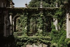 an old building with ivy growing on it's walls and arches in the middle