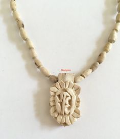 "Tulsi Mala Necklace with Tulsi Radhe Pendant (Radhe Handcarved in Sanskrit). This beaded necklace can be worn by men as well as women. Tulsi beads are made from Tulsi (Holy Basil) plant wood, considered as most sacred in India. Tulsi plant is worshipped in India and the food offered to Indian Gods is incomplete without the offereing of Tulsi leaves along with it. Tulsi Mala provides protection to the wearer and is said to maintain Health, provide Peace of Mind and reduce Stress. They are used t Wooden Beads Necklace For Meditation And Festivals, Traditional Wooden Beads Mala As Gift, Wooden Beads Necklaces For Meditation And Festivals, Spiritual Wooden Beads Necklace For Puja, Traditional 108 Beads Necklace For Festival, Bohemian Wooden Beads Jewelry For Puja, Handmade Mala Amulet For Rituals, Handmade Amulet Mala For Rituals, Bohemian Necklace With 108 Beads For Puja