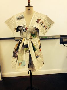 a dress made out of newspapers on a mannequin